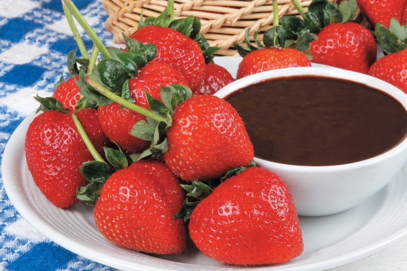 Fresh strawberries served with a rich chocolate dipping sauce for an interactive dessert experience.